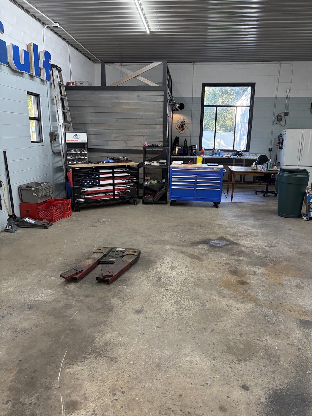 Inside the DrivePoint Automotive bay: toolboxes, parts rack and the front desk